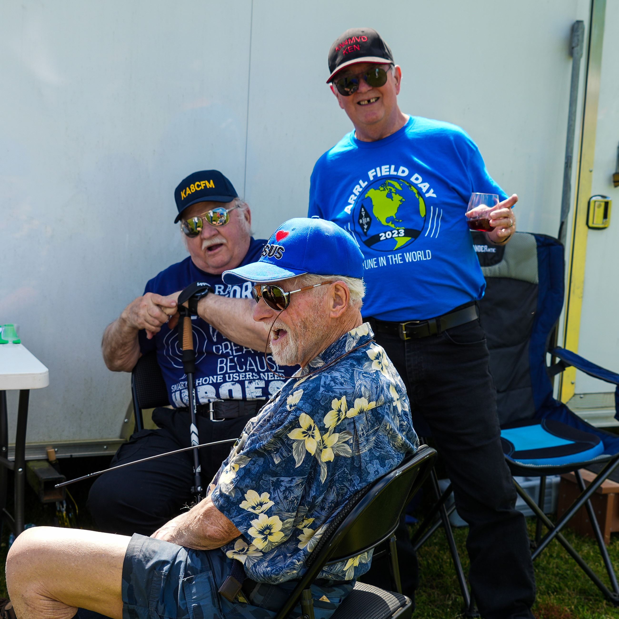 Three veteran men in a group smiling