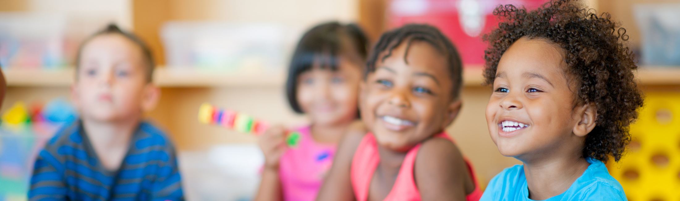 Four preschoolers smiling