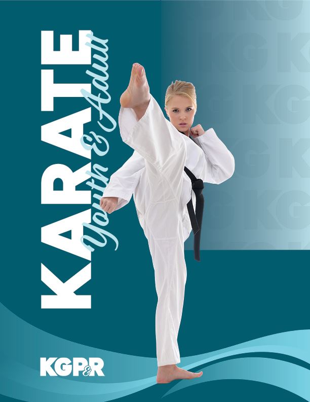 Woman kicking her leg up in the air in a karate uniform.